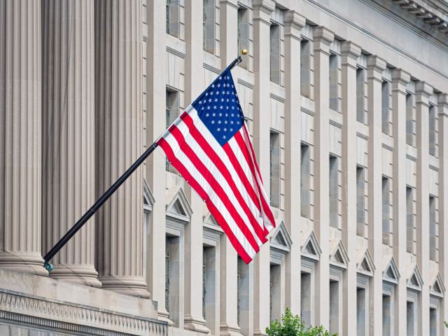 American flag on the facade of a historic building